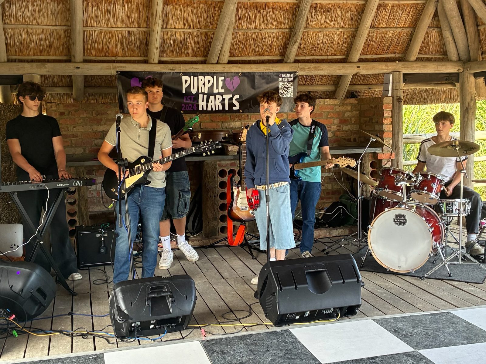 Purple Harts playing live under a barn roof