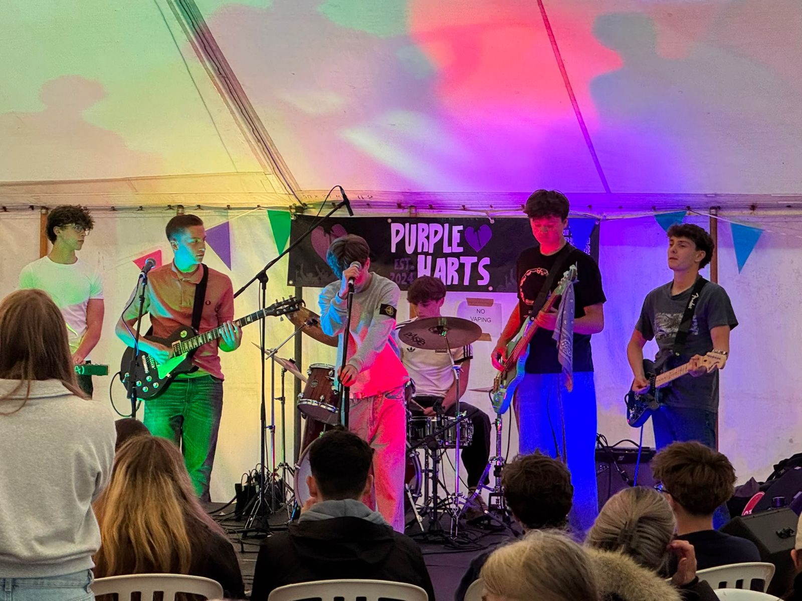 Purple Harts playing in a marquee